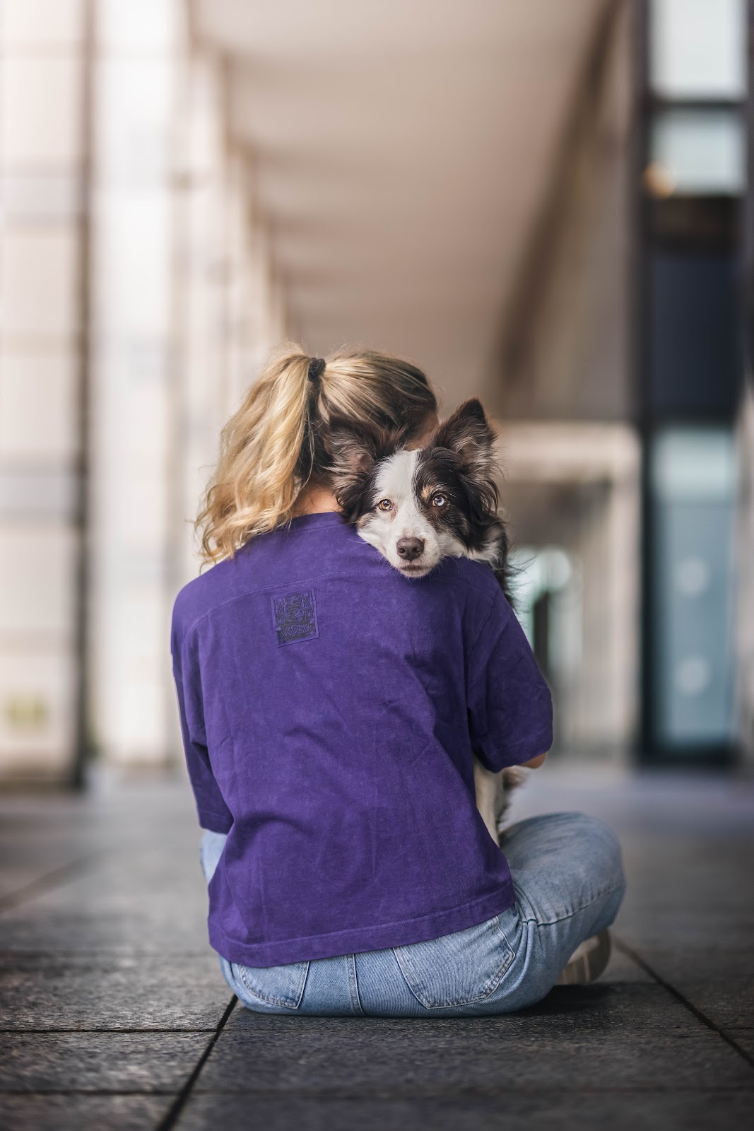 Roni hugging her border collie over her shoulder